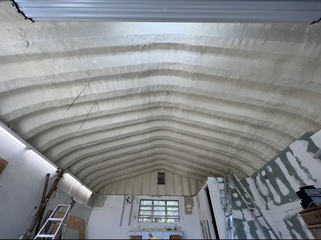 Spray polyurethane foam applied to the underside of a metal roof deck in Berlin